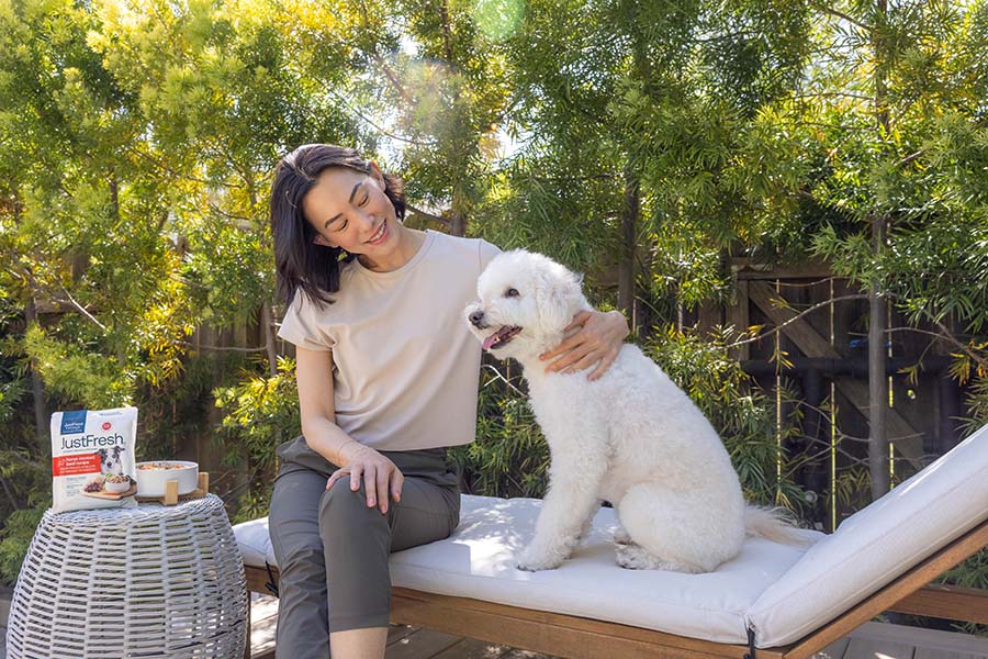 white doodle outside with human